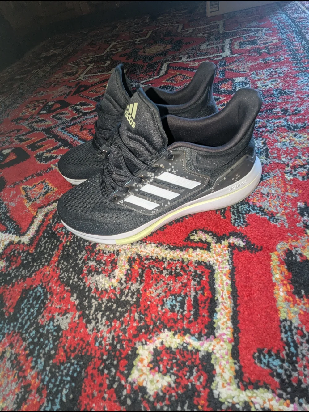 adidas Black Athletic Running Shoes with White Stripes and Subtle Yellow Accent